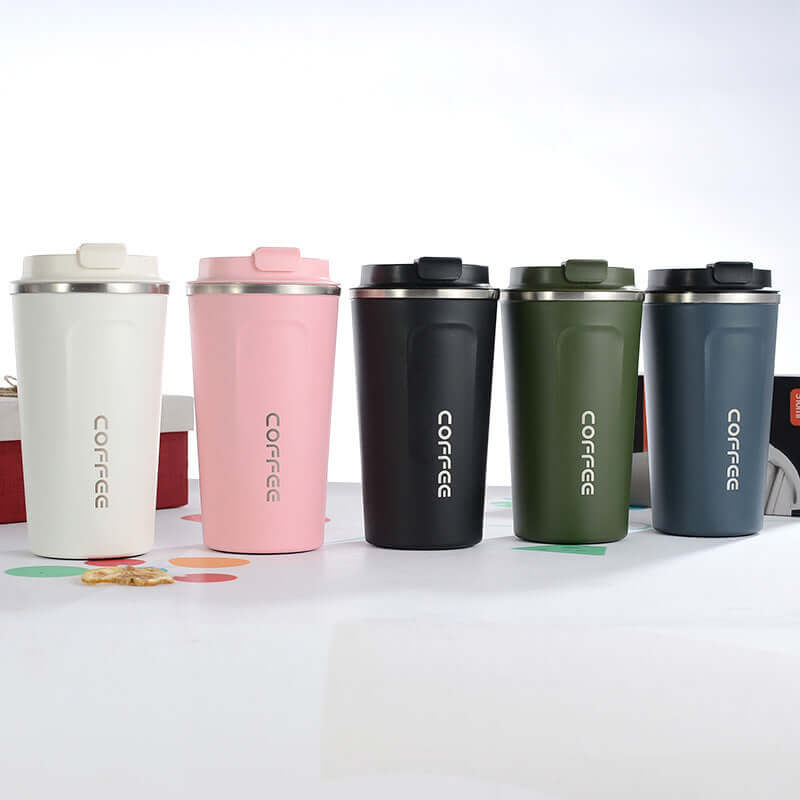 Set of four insulated stainless steel travel mugs in pink, black, green, and navy, perfect for coffee and tea on the go.