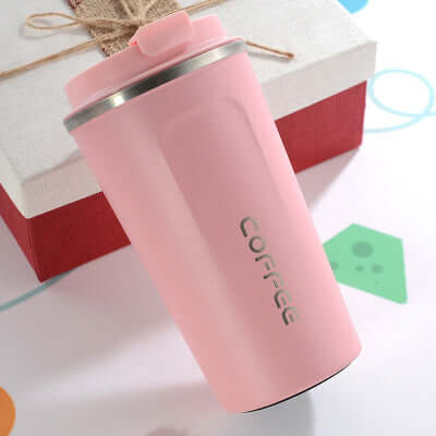 Pink insulated coffee mug featuring a sleek design, perfect for travel and maintaining beverage temperature.