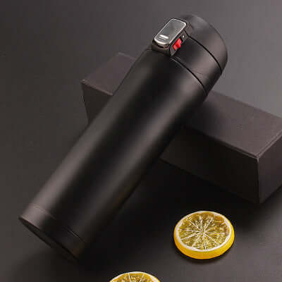 Premium insulated black travel mug on a dark surface with lemon slices, ideal for coffee, tea, and on-the-go hydration.