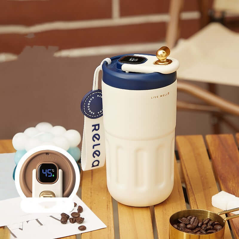 Smart stainless steel travel mug with temperature control display and modern design, perfect for coffee lovers.
