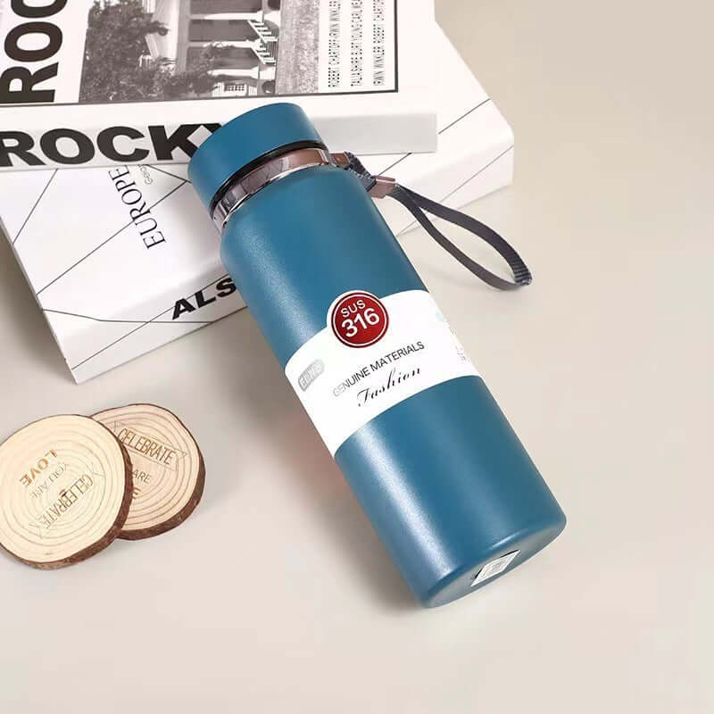 Stylish stainless steel vacuum insulation cup on a stylish book background, perfect for on-the-go beverages.