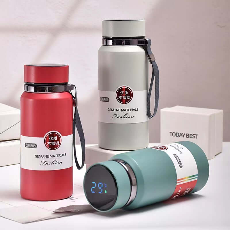 Stylish stainless steel vacuum smart insulation cups in red, green, and white, showcasing modern design and temperature display.